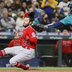 SEATTLE, WASHINGTON - OCTOBER 01: David Fletcher #22 of the Los Angeles Angels scores past Tom Murphy #2 of the Seattle Mariners during the third inning at T-Mobile Park on October 01, 2021 in Seattle, Washington. (Photo by Steph Chambers/Getty Images)
