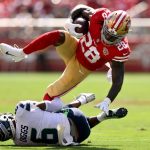 SANTA CLARA, CALIFORNIA - OCTOBER 03: Trey Sermon #28 of the San Francisco 49ers dives over Quandre Diggs #6 of the Seattle Seahawks during the first quarter at Levi's Stadium on October 03, 2021 in Santa Clara, California. (Photo by Ezra Shaw/Getty Images)