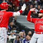SEATTLE, WASHINGTON - OCTOBER 03: Shohei Ohtani #17 and Jose Rojas #18 of the Los Angeles Angels react after Rojas scored on a double by David Fletcher #22 during the second inning against the Seattle Mariners at T-Mobile Park on October 03, 2021 in Seattle, Washington. (Photo by Steph Chambers/Getty Images)