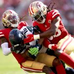 SANTA CLARA, CALIFORNIA - OCTOBER 03: Tyler Lockett #16 of the Seattle Seahawks is tackled by JaMycal Hasty #23 and Marcell Harris #36 of the San Francisco 49ers during the third quarter at Levi's Stadium on October 03, 2021 in Santa Clara, California. (Photo by Ezra Shaw/Getty Images)