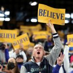 SEATTLE, WASHINGTON - OCTOBER 03: Fans hold "believe" signs during the game between the Seattle Mariners and the Los Angeles Angels at T-Mobile Park on October 03, 2021 in Seattle, Washington. (Photo by Steph Chambers/Getty Images)
