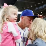 SEATTLE, WASHINGTON - OCTOBER 03: Kyle Seager #15 of the Seattle Mariners kisses his wife Julie Seager after losing to the Los Angeles Angels 7-3 to end their season at T-Mobile Park on October 03, 2021 in Seattle, Washington. (Photo by Steph Chambers/Getty Images)