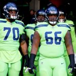 SEATTLE, WASHINGTON - OCTOBER 07: Offensive tackle Cedric Ogbuehi #70 and guard Gabe Jackson #66 of the Seattle Seahawks wait to take the field against the Los Angeles Rams at Lumen Field on October 07, 2021 in Seattle, Washington. (Photo by Steph Chambers/Getty Images)