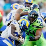 SEATTLE, WASHINGTON - OCTOBER 07: Running back Darrell Henderson #27 of the Los Angeles Rams is tackled by middle linebacker Bobby Wagner #54 of the Seattle Seahawks in the first half at Lumen Field on October 07, 2021 in Seattle, Washington. (Photo by Steph Chambers/Getty Images)