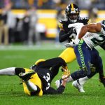 PITTSBURGH, PENNSYLVANIA - OCTOBER 17: Travis Homer #25 of the Seattle Seahawks rushes ahead of Josh Johnson #34 of the Seattle Seahawks during the first quarter at Heinz Field on October 17, 2021 in Pittsburgh, Pennsylvania. (Photo by Joe Sargent/Getty Images)