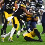 PITTSBURGH, PENNSYLVANIA - OCTOBER 17: Alex Collins #41 of the Seattle Seahawks rushes ahead of Joe Haden #23 and Devin Bush #55 of the Pittsburgh Steelers during the third quarter at Heinz Field on October 17, 2021 in Pittsburgh, Pennsylvania. (Photo by Joe Sargent/Getty Images)