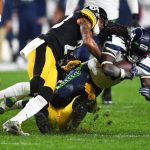 PITTSBURGH, PENNSYLVANIA - OCTOBER 17: Alex Collins #41 of the Seattle Seahawks rushes ahead of Joe Haden #23 and Devin Bush #55 of the Pittsburgh Steelers during the third quarter at Heinz Field on October 17, 2021 in Pittsburgh, Pennsylvania. (Photo by Joe Sargent/Getty Images)