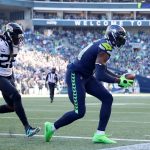 SEATTLE, WASHINGTON - OCTOBER 31: DK Metcalf #14 of the Seattle Seahawks catches the ball over Shaquill Griffin #26 of the Jacksonville Jaguars for a touchdown during the third quarter at Lumen Field on October 31, 2021 in Seattle, Washington. (Photo by Abbie Parr/Getty Images)