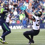 SEATTLE, WASHINGTON - OCTOBER 31: Jamal Agnew #39 of the Jacksonville Jaguars is unable to make the catch over Sidney Jones #23 of the Seattle Seahawks during the fourth quarter at Lumen Field on October 31, 2021 in Seattle, Washington. (Photo by Abbie Parr/Getty Images)