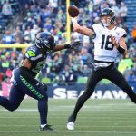 SEATTLE, WASHINGTON - OCTOBER 31: Trevor Lawrence #16 of the Jacksonville Jaguars thows the ball while under pressure by Jordyn Brooks #56 of the Seattle Seahawks during the fourth quarter at Lumen Field on October 31, 2021 in Seattle, Washington. (Photo by Abbie Parr/Getty Images)