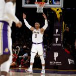 
              Los Angeles Lakers guard Russell Westbrook (0) reacts after forward LeBron James (6) scoring a three-point basket against the Memphis Grizzlies during the first half of an NBA basketball game in Los Angeles, Sunday, Oct. 24, 2021. (AP Photo/Ringo H.W. Chiu)
            