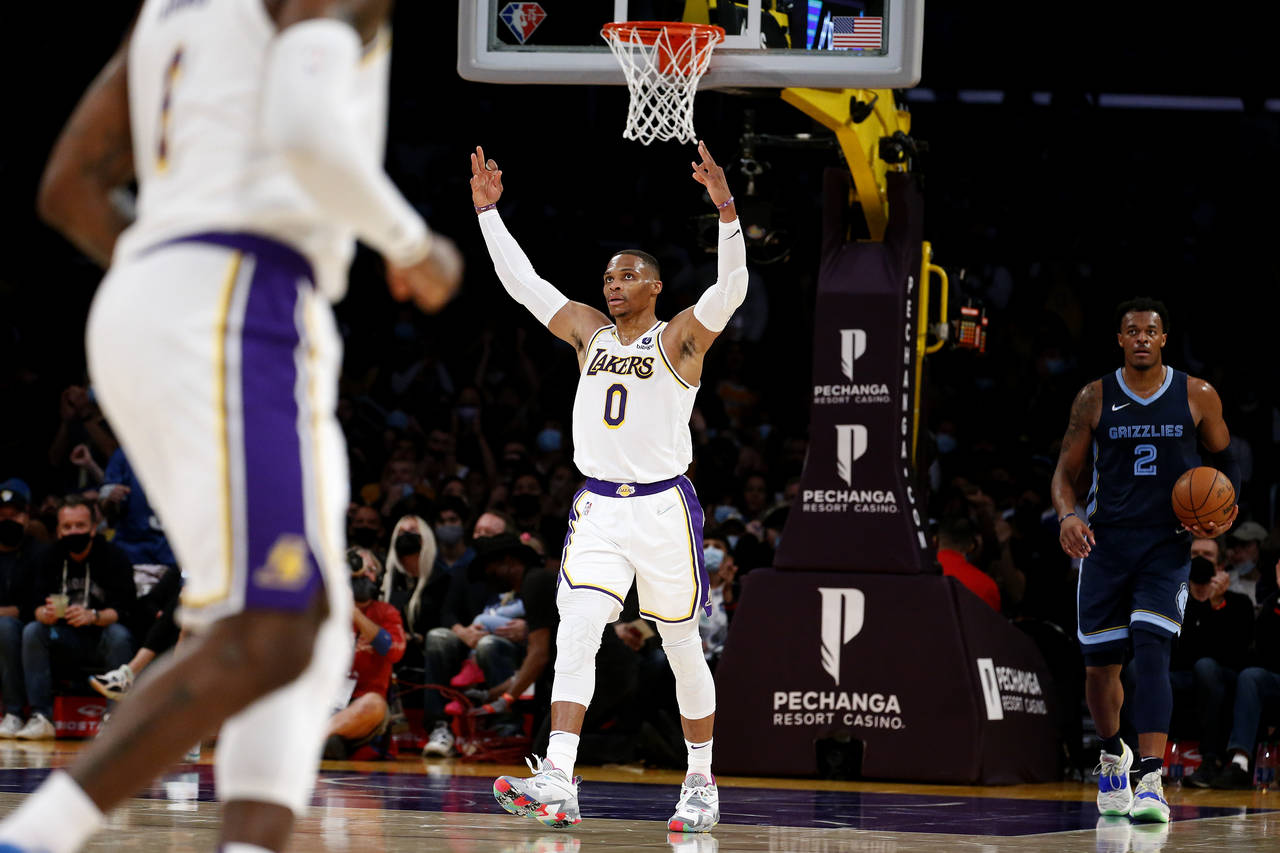 Los Angeles Lakers guard Russell Westbrook (0) reacts after forward LeBron James (6) scoring a thre...