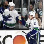 
              Vancouver Canucks' Bo Horvat (53) is congratulated by teammates after scoring against the Seattle Kraken duriong the second period of an NHL hockey game Saturday, Oct. 23, 2021, in Seattle. (AP Photo/Elaine Thompson)
            