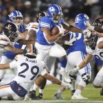 
              BYU running back Tyler Allgeier (25) runs the ball as several Virginia players try to tackle him during the first half of an NCAA college football game Saturday, Oct. 30, 2021, in Provo, Utah. (AP Photo/George Frey)
            