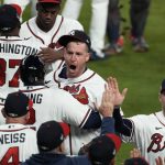 
              Atlanta Braves relief pitcher Will Smith, center, celebrates their win in Game 4 of baseball's World Series between the Houston Astros and the Atlanta Braves Saturday, Oct. 30, 2021, in Atlanta. The Braves won 3-2, to lead the series 3-1 games. (AP Photo/Brynn Anderson)
            