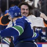 
              Philadelphia Flyers' Zack MacEwen, back, and Vancouver Canucks' Luke Schenn fight during the second period of an NHL hockey game Thursday, Oct. 28, 2021, in Vancouver, British Columbia. (Darryl Dyck/The Canadian Press via AP)
            