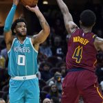 
              Charlotte Hornets' Miles Bridges (0) shoots over Cleveland Cavaliers' Evan Mobley (4) during the second half of an NBA basketball game Friday, Oct. 22, 2021, in Cleveland. Charlotte won 123-112. (AP Photo/Tony Dejak)
            
