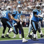 
              Carolina Panthers quarterback Sam Darnold (14) runs the ball for a touchdown as guard Dennis Daley (65) and guard John Miller (67) help against pressure from Dallas Cowboys defenders Osa Odighizuwa (97) and safety Jayron Kearse, right, in the first half of a NFL football game in Arlington, Texas, Sunday, Oct. 3, 2021. (AP Photo/Michael Ainsworth)
            
