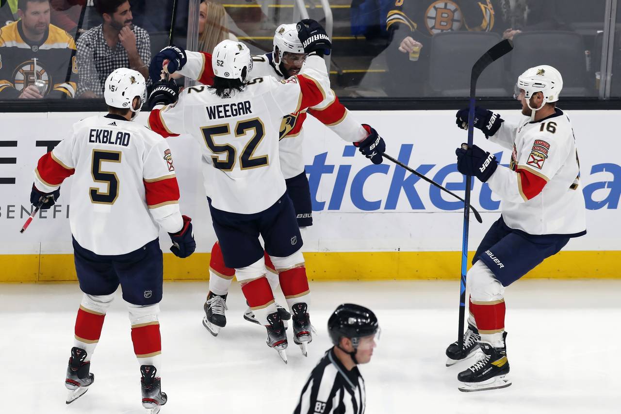 Florida Panthers' Anthony Duclair, center right, celebrates his goal with Aaron Ekblad (5), MacKenz...