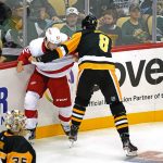 
              Pittsburgh Penguins' Brian Dumoulin (8) and Detroit Red Wings' Tyler Bertuzzi (59) fight during the first period of a preseason NHL hockey game in Pittsburgh, Sunday, Oct. 3, 2021. (AP Photo/Gene J. Puskar)
            