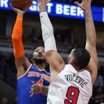 
              New York Knicks guard Derrick Rose, left, drives to the basket against Chicago Bulls center Nikola Vucevic during the first half of an NBA basketball game Thursday, Oct. 28, 2021, in Chicago. (AP Photo/Nam Y. Huh)
            