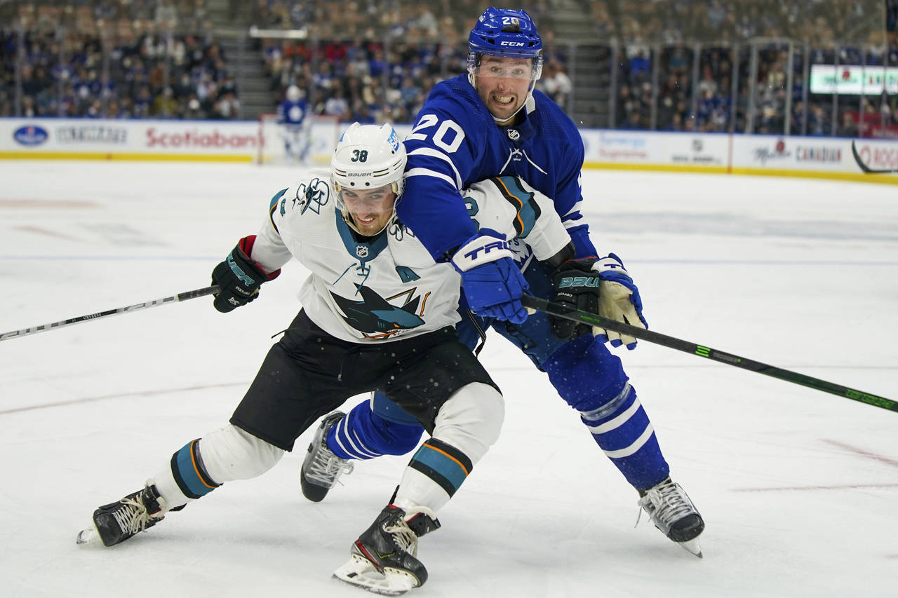 San Jose Sharks defenseman Mario Ferraro (38) and Toronto Maple Leafs forward Nick Ritchie (20) jos...