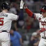 
              Atlanta Braves' Joc Pederson, right, celebrates with Freddie Freeman (5) after hitting a home run off New York Mets pitcher Carlos Carrasco in the third inning of a baseball game Saturday, Oct. 2, 2021, in Atlanta. (AP Photo/Ben Margot)
            