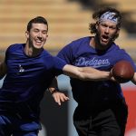 
              Los Angeles Dodgers' Walker Buehler, left and Clayton Kershaw play football before Game 4 of baseball's National League Championship Series between the Atlanta Braves and Los Angeles Dodgers, Wednesday, Oct. 20, 2021, in Los Angeles. (AP Photo/Jae Hong)
            