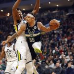 
              Milwaukee Bucks guard Justin Robinson (55) looks to pass around the Utah Jazz during the first half of an NBA basketball game Sunday, Oct. 31, 2021, in Milwaukee. (AP Photo/Jeffrey Phelps)
            