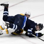 
              Winnipeg Jets' Neal Pionk (4) falls on Nashville Predators' Nick Cousins (21) during the second period of NHL hockey game action in Winnipeg, Manitoba, Saturday, Oct. 23, 2021. (Fred Greenslade/The Canadian Press via AP)
            
