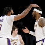 
              Los Angeles Lakers forwards Carmelo Anthony, right, is greeted by Anthony Davis (3) after Anthony scoring a three-point basket against the Memphis Grizzlies during the first half of an NBA basketball game in Los Angeles, Sunday, Oct. 24, 2021. (AP Photo/Ringo H.W. Chiu)
            