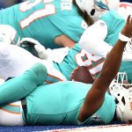 
              Miami Dolphins quarterback Tua Tagovailoa (1) celebrates after crossing the goal line for a touchdown during the second half of an NFL football game against the Buffalo Bills, Sunday, Oct. 31, 2021, in Orchard Park, N.Y. (AP Photo/Adrian Kraus)
            