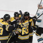 
              Boston Bruins' Brad Marchand (63) celebrates his goal with teammates as San Jose Sharks' Logan Couture (39) skates away during the first period of an NHL hockey game, Sunday, Oct. 24, 2021, in Boston. (AP Photo/Michael Dwyer)
            