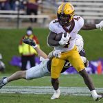 
              Minnesota running back Mar'Keise Irving (4) is tackled by Northwestern defensive back Bryce Jackson during the second half of an NCAA college football game in Evanston, Ill., Saturday, Oct. 30, 2021. (AP Photo/Nam Y. Huh)
            