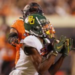 
              Oklahoma State cornerback Jarrick Bernard-Converse, rear, reaches in to break up a pass intended for Baylor wide receiver Tyquan Thornton in the second half of an NCAA college football game, Saturday, Oct. 2, 2021, in Stillwater, Okla. (AP Photo/Sue Ogrocki)
            