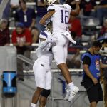 
              Washington wide receiver Rome Odunze (16) celebrates with running back Cameron Davis after scoring a touchdown during the fourth quarter of the team's NCAA college football game against Arizona on Friday, Oct. 22, 2021, in Tucson, Ariz. (AP Photo/Chris Coduto)
            