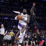 
              Los Angeles Lakers forward LeBron James, left, shoots as Houston Rockets guard Kevin Porter Jr. defends during the first half of an NBA basketball game Sunday, Oct. 31, 2021, in Los Angeles. (AP Photo/Mark J. Terrill)
            