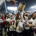 
              Fresno State players hoist the Old Oil Can trophy while celebrating the team's 30-20 win against San Diego State in an NCAA college football game Saturday, Oct. 30, 2021, in Carson, Calif. (AP Photo/Jae C. Hong)
            
