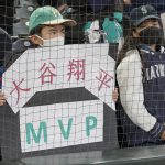 
              A fan holds a sign advocating for Los Angeles Angels' Shohei Ohtani to be named MLB's most valuable player before a baseball game between the Seattle Mariners and the Angels, Sunday, Oct. 3, 2021, in Seattle. (AP Photo/Ted S. Warren)
            