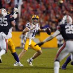 
              LSU quarterback Max Johnson (14) looks to pass under pressure from Auburn defensive end Colby Wooden (25) in the second half of an NCAA college football game in Baton Rouge, La., Saturday, Oct. 2, 2021. Auburn won 24-19. (AP Photo/Gerald Herbert)
            