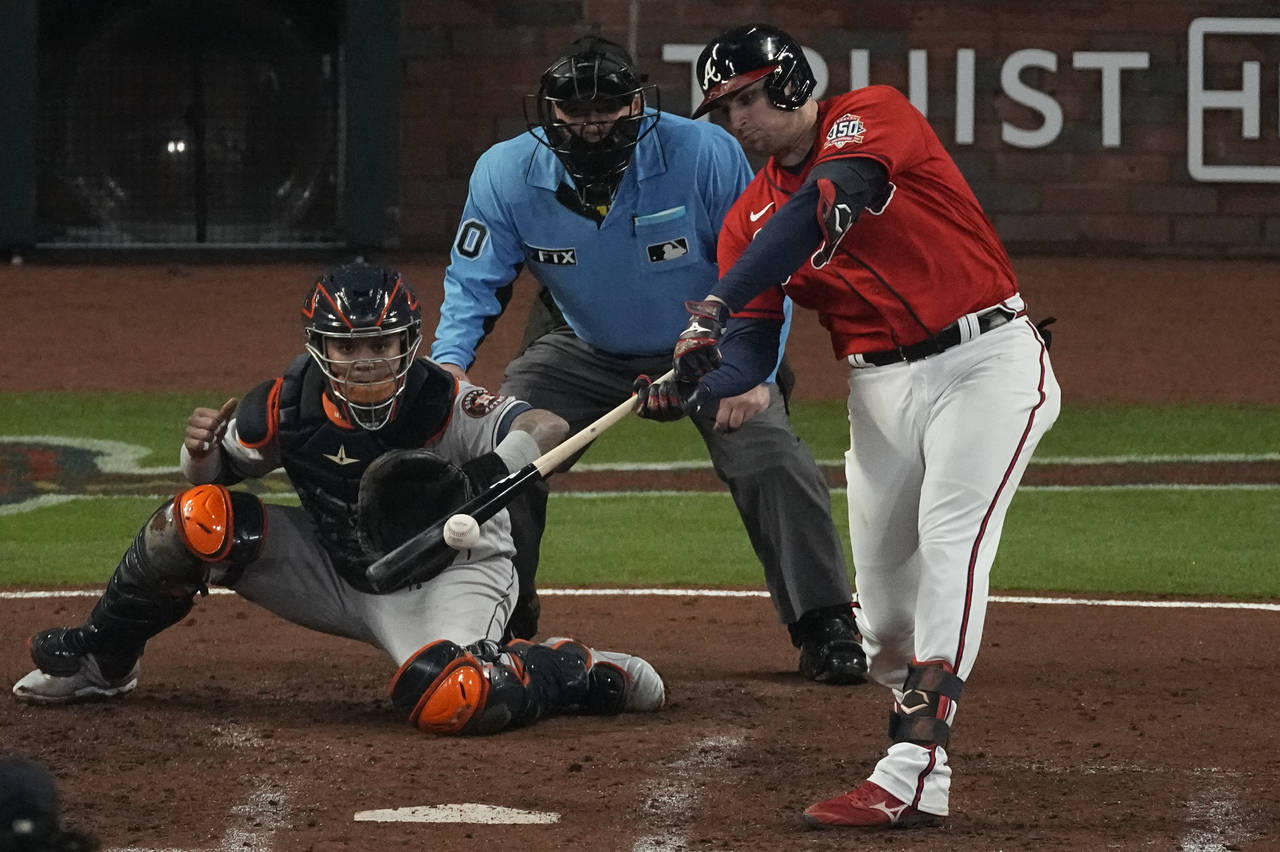 Atlanta Braves' Austin Riley hits a RBI-double during the third inning in Game 3 of baseball's Worl...