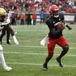 
              Louisville quarterback Malik Cunningham (3) outruns Boston College linebacker Kam Arnold (27) for a touchdown in the first half of an NCAA college football game in Louisville, Ky., Saturday, Oct. 23, 2021. (AP Photo/Timothy D. Easley)
            