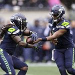 
              Seattle Seahawks quarterback Geno Smith, right, hands off to running back Alex Collins during the first half of an NFL football game against the New Orleans Saint, Monday, Oct. 25, 2021, in Seattle. (AP Photo/John Froschauer)
            