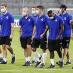 
              FILE-This Sept. 14, 2021 taken photo shows Duisburg's players arrive with face masks due to the coronavirus rules on the pitch prior the 1st round German Soccer Cup match between MSV Duisburg and Borussia Dortmund in Duisburg, Germany. The German soccer league says more than 90% of players, coaches and staff from the 36 clubs in the Bundesliga and second division have received vaccines against the coronavirus. (AP Photo/Martin Meissner)
            