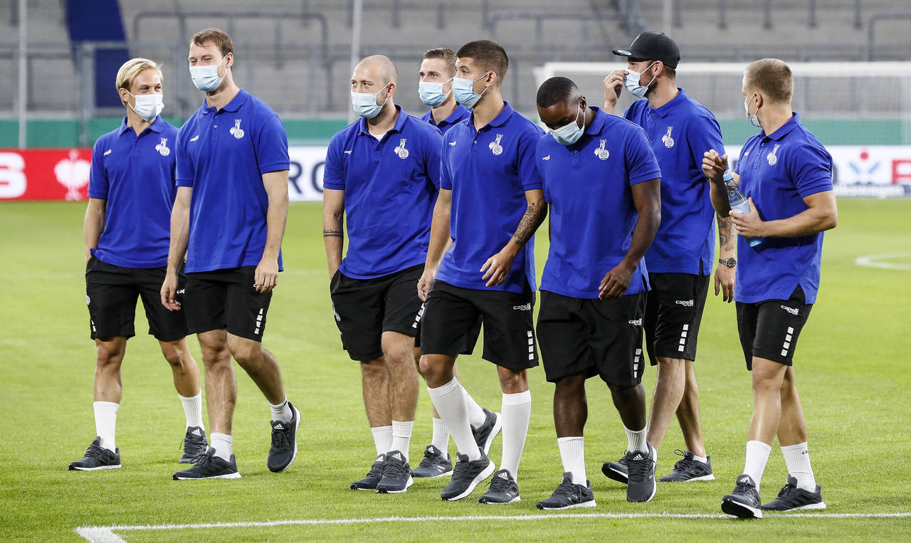 FILE-This Sept. 14, 2021 taken photo shows Duisburg's players arrive with face masks due to the cor...