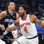 
              Orlando Magic's Jalen Suggs, left, fouls New York Knicks' Derrick Rose, who was headed to the basket during the first half of an NBA basketball game Friday, Oct. 22, 2021, in Orlando, Fla. (AP Photo/John Raoux)
            