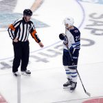 
              Winnipeg Jets center Dominic Toninato (21) pleads his case with referee Ian Walsh (29) after he was called for interference during overtime in the team's NHL hockey game against the San Jose Sharks, Saturday, Oct. 30, 2021, in San Jose, Calif. The Sharks won 2-1. (AP Photo/D. Ross Cameron)
            