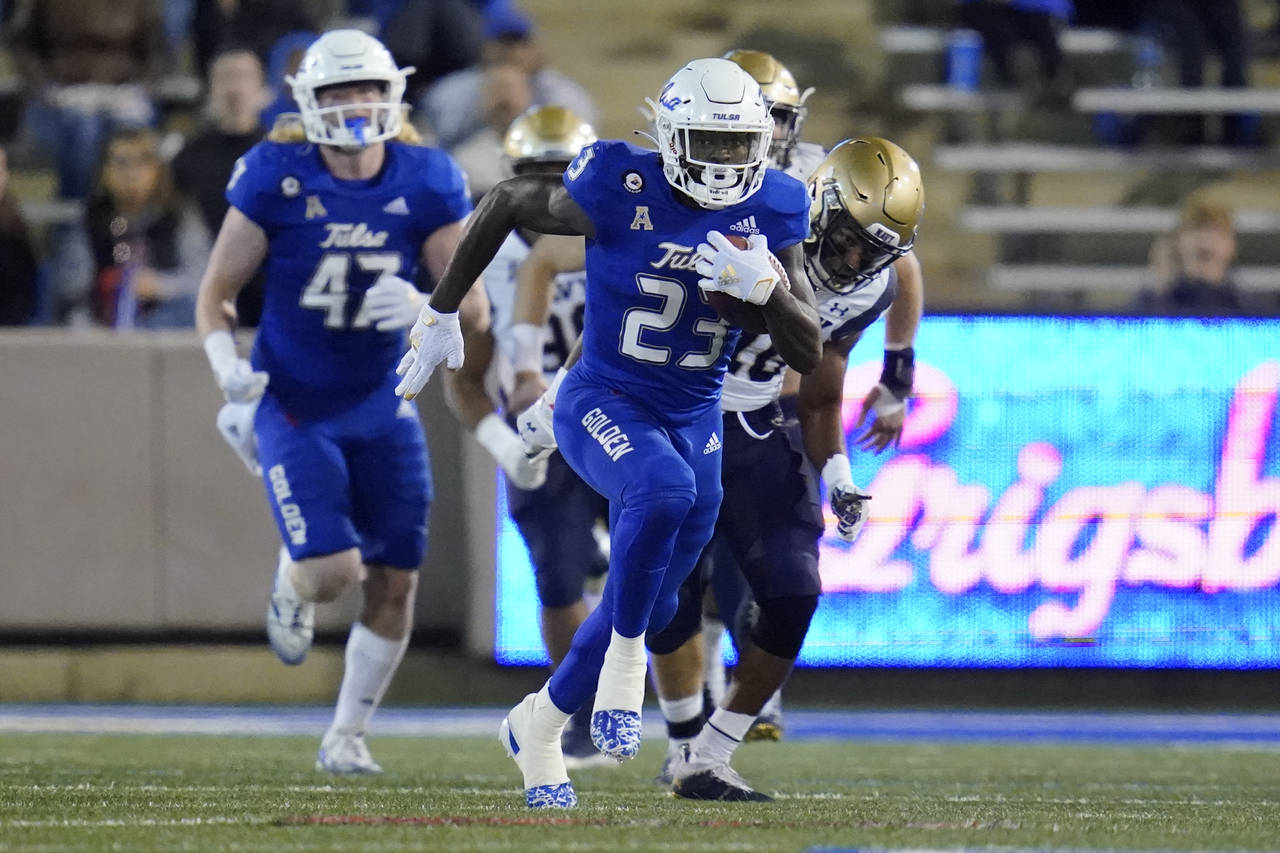 Tulsa running back Anthony Watkins (23) takes off on a 78-yard run in the first half of an NCAA col...