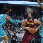 
              Cleveland Cavaliers' Ricky Rubio (3) drives between Charlotte Hornets' Miles Bridges (0) and Ish Smith (10) in the first half of an NBA basketball game, Friday, Oct. 22, 2021, in Cleveland. (AP Photo/Tony Dejak)
            