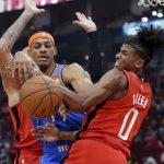 
              Oklahoma City Thunder forward Darius Bazley, left, and Houston Rockets guard Jalen Green (0) become entangled as they battle for a rebound during the first half of an NBA basketball game Friday, Oct. 22, 2021, in Houston. (AP Photo/Michael Wyke)
            